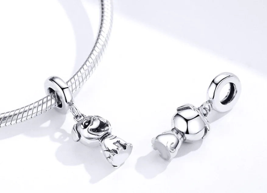 Silver bracelet with a dog-shaped charm on a white background