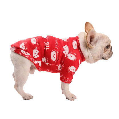 Dog wearing a red outfit with white patterns on a white background