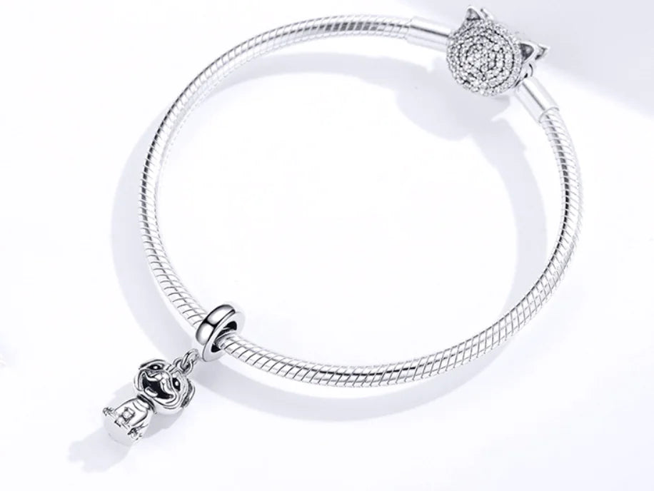 Silver bracelet with charms on a white background
